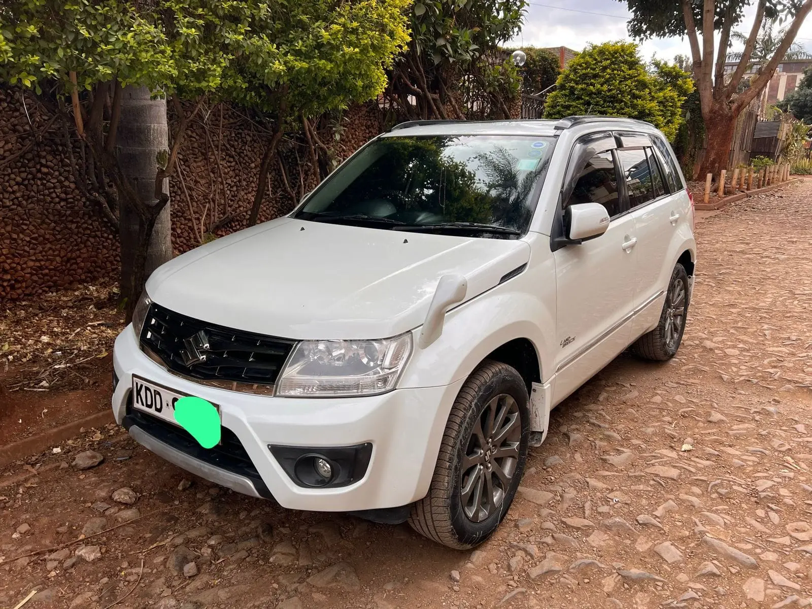 White Suzuki Grand Vitara compact SUV photographed from the front